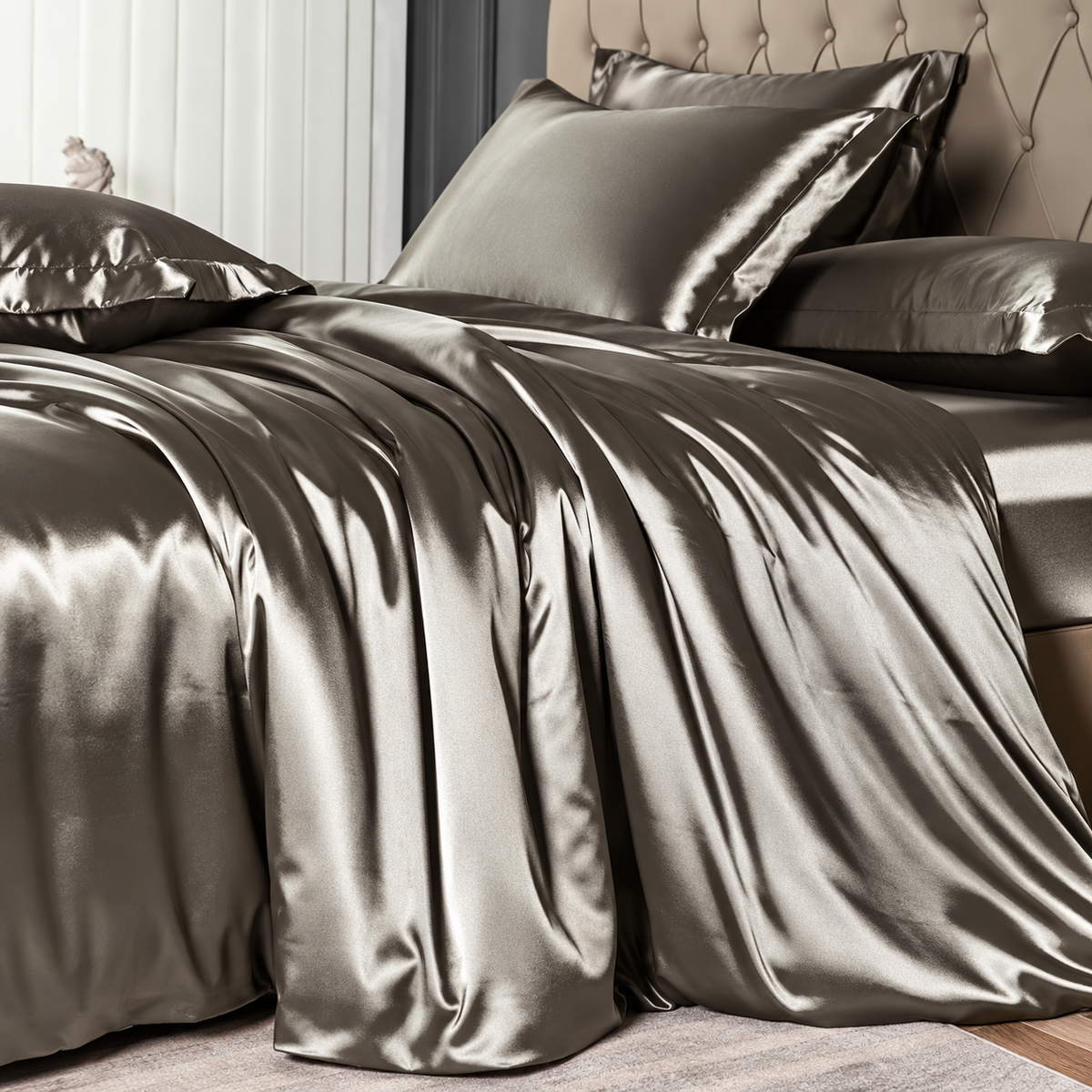Close-up of glossy pearl-gray satin bedding in an elegant bedroom