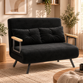 Black tufted loveseat with wooden armrests styled in a warm, contemporary living room